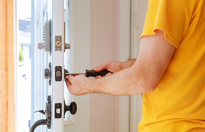 locksmith repairing a residential deadbolt